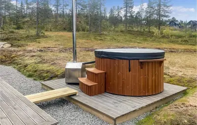 a wooden hot tub sitting on a wooden deck at Pet Friendly Home In Trysil With Wifi in Trysil