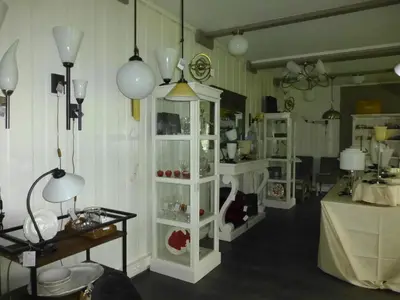 a room with white cabinets and a table and lamps at Løvheim Gjestehus in Sauland