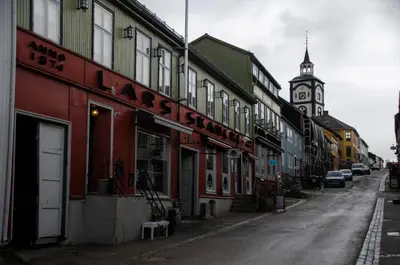a street with a clock tower in the distance at Skanckegårdene AS in Røros