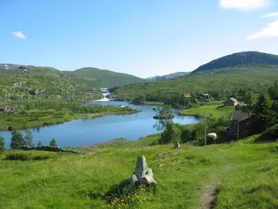 a view of a river in a valley with mountains at Sæbø Camping in Eidfjord