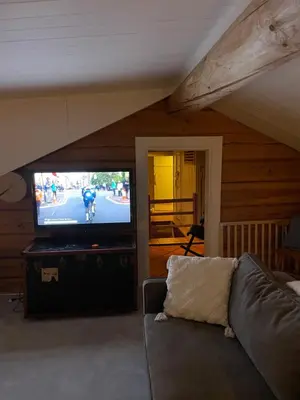 a living room with a couch and a flat screen tv at Solsetra - Mountain Majesty Family Log Cabin in Hovden