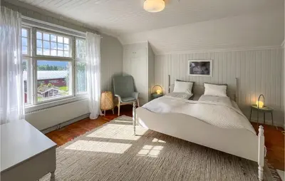 a bedroom with a large bed and a window at Gorgeous Home In Koppang With Sauna in Koppang