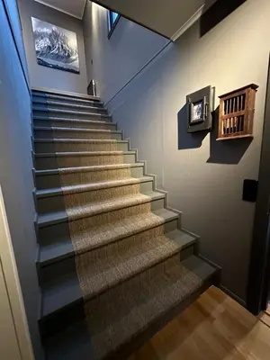 a staircase in a building with a picture on the wall at Hemsedal 200m2 /5 sov/10 senger/2 familier in Torset