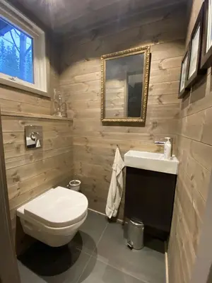 a bathroom with a toilet and a sink and a mirror at Hemsedal 200m2 /5 sov/10 senger/2 familier in Torset