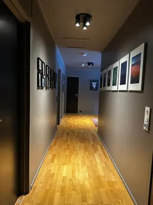 an empty hallway with paintings on the walls and a hard wood floor at Hemsedal 200m2 /5 sov/10 senger/2 familier in Torset