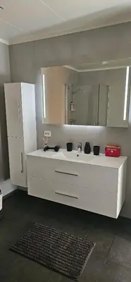 a bathroom with a white sink and a mirror at Panorama view in Stranda