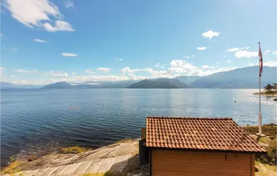 a house on the shore of a large body of water at Amazing Home In Tørvikbygd With Wifi in Tyrvikbygd