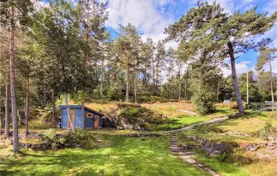 a small shed in a field with trees at Amazing Home In Tørvikbygd With Wifi in Tyrvikbygd