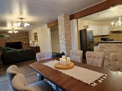 a kitchen and dining room with a table and chairs at Mountain & Fjord View Apartment in Stryn