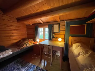 a room with a desk and a bed in a cabin at Elveseter - log cabin with an amazing view in Venabygd
