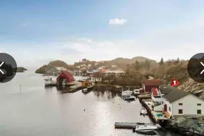 a view of a harbor with boats in the water at Flott rorbu på idylliske Langevåg/Bømlo in Bømlo