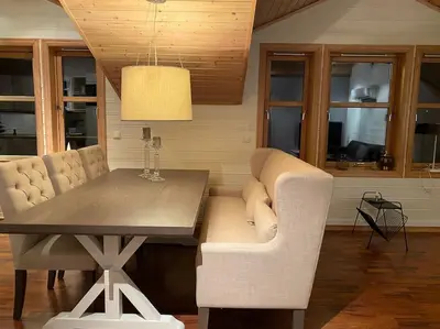 a dining room with a table and white chairs at Flott rorbu på idylliske Langevåg/Bømlo in Bømlo