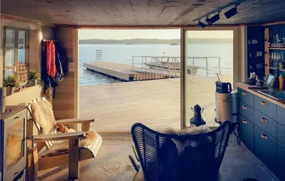 a kitchen with a view of a boat on the water at Stunning Home In Fitjar With Wifi in Fitjar