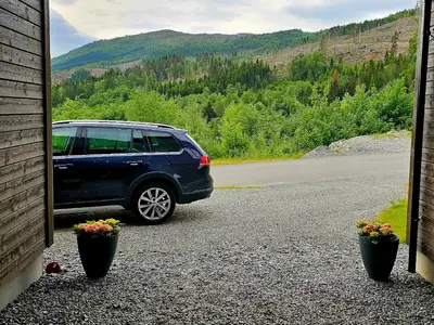 a blue suv parked on the side of a road at Panorama view in Stranda