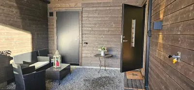 a door leading to a room with a table and a table sidx sidx at Panorama view in Stranda