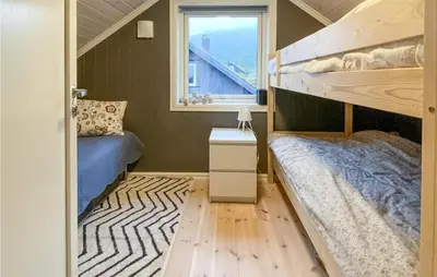 a small bedroom with a bunk bed and a window at Nice Home In Rauland With House A Mountain View in Rauland
