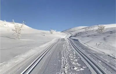 a snow covered road with footprints in the middle at Nice Home In Rauland With House A Mountain View in Rauland