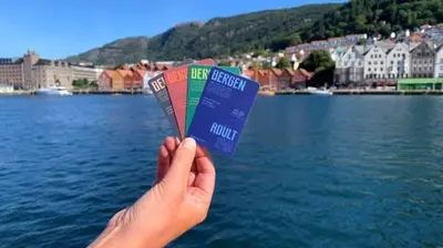 a person holding up a book in front of a body of water at Dinbnb Apartments I New 2021 I Affordable Option in Bergen