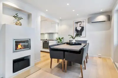 a living room with a piano and a fireplace at Dinbnb Homes I Historical 1850 House in Bergen