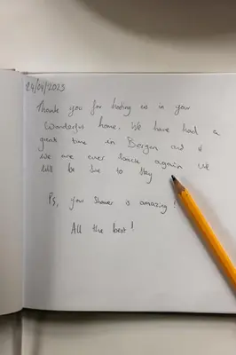a handwritten letter with a pencil on a paper at Dinbnb Apartments I New 2021 I SONOS and SMART TV in Bergen