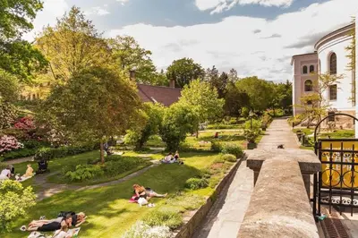 a view of a park with people sitting in the grass at Dinbnb Apartments I New 2021 I SONOS and SMART TV in Bergen