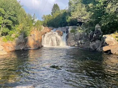 a waterfall in the middle of a body of water at Nakkentunet - familievennlig hus på gårdstun. in Ørskog