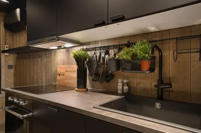 a kitchen with a sink and some plants on the wall at Hide Hut - Amazing view 50 min from Oslo in Stange