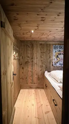 a wooden room with a bed and a wooden floor at Liaplassen Mountain Chalet - Beitostølen in Beitostøl