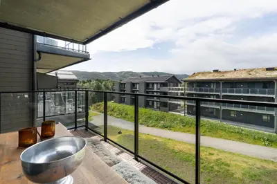 a bathroom with a bowl sink on a balcony at Spacious and modern apartment in the heart of Geilo, perfect year round! in Geilo