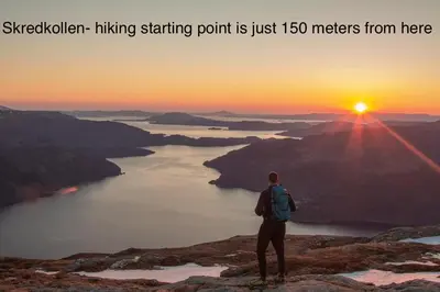 a man standing on top of a mountain watching the sunset at Apartment-A near Etne-Odda in Etnesjøen
