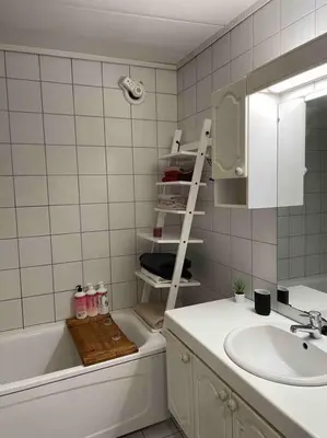 a bathroom with a sink and a tub and a mirror at The old bakery in Sandviken in Bergen