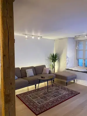 a living room with a couch and a table at The old bakery in Sandviken in Bergen