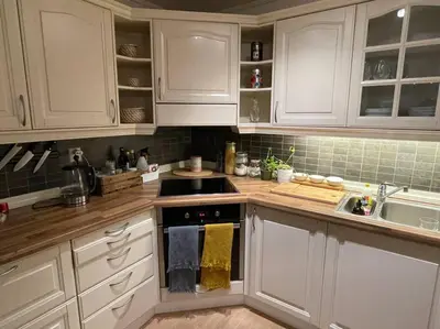 a kitchen with white cabinets and a stove top oven at The old bakery in Sandviken in Bergen