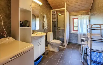 a bathroom with a toilet and a sink and a shower at 3 Bedroom Stunning Home In Vossestrand in Vossestrand