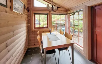 a dining room with a wooden table and chairs at 3 Bedroom Stunning Home In Vossestrand in Vossestrand