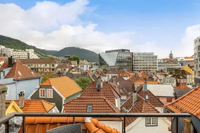 a view of a city with buildings and roofs at Dinbnb Apartments I Historical Two-Floor Apartment with Rooftop Panorama I 1645 Heritage in Bergen