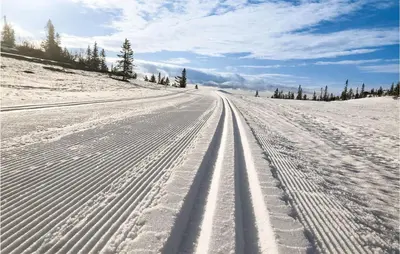 a snow covered road with tire tracks in the snow at Lovely Home In Veggli With Kitchen in Veggli