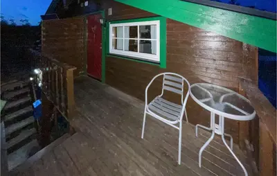 a chair sitting on the front porch of a house at 1 Bedroom Amazing Apartment In Trysil in Trysil