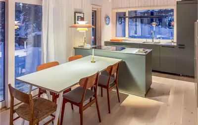 a kitchen with a table and chairs and a sink at 3 Bedroom Amazing Home In Tuddal in Tuddal