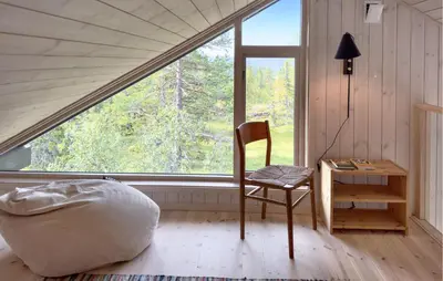a room with a chair and a desk and a window at 3 Bedroom Amazing Home In Tuddal in Tuddal