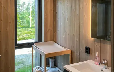 a small bathroom with a sink and a window at 4 Bedroom Nice Home In Tuddal in Tuddal