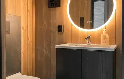 a bathroom with a sink and a mirror at 4 Bedroom Nice Home In Tuddal in Tuddal