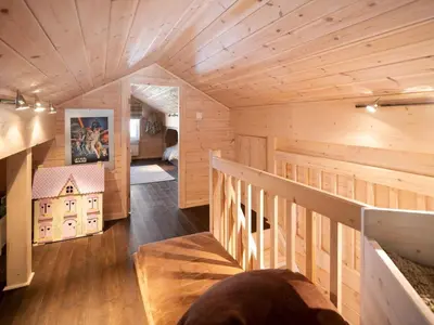 a wooden house with a staircase in a room at Saballie - Cosy cabin - sunny location! in Slåtto