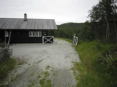 a barn with two gates in front of it at Saballie - Cosy cabin - sunny location! in Slåtto