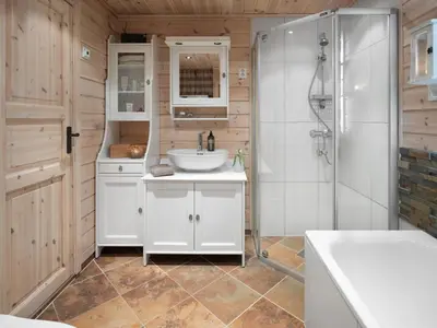 a bathroom with a sink and a shower at Saballie - Cosy cabin - sunny location! in Slåtto