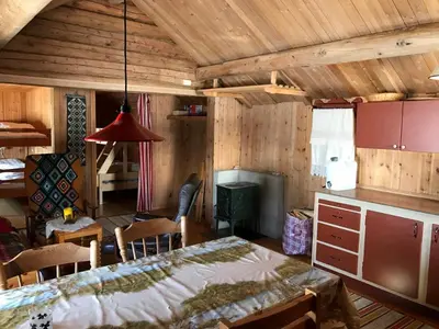 a kitchen and dining room with a table and chairs at Båtstø Camping in Elga