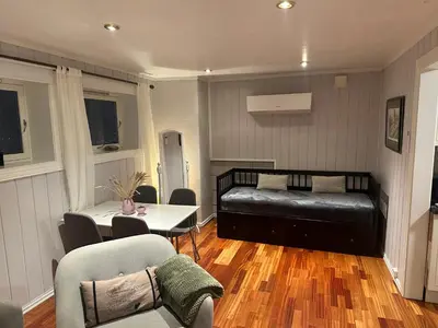 a living room with a bed and a table and chairs at Leilighet for korttidsleie in Otta
