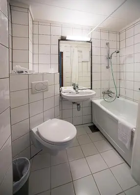 a bathroom with a toilet and a sink and a tub at Stalheim Hotel in Stalheim