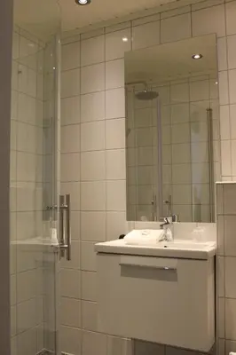 a bathroom with a sink and a shower with a mirror at Stalheim Hotel in Stalheim