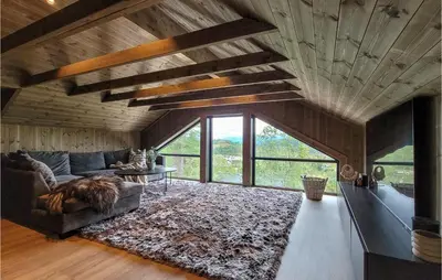 a living room with a couch and a table at Awesome Home In Norheimsund With Sauna in Norheimsund